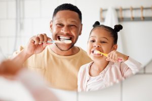 Dad & Daughter brushing teeth together